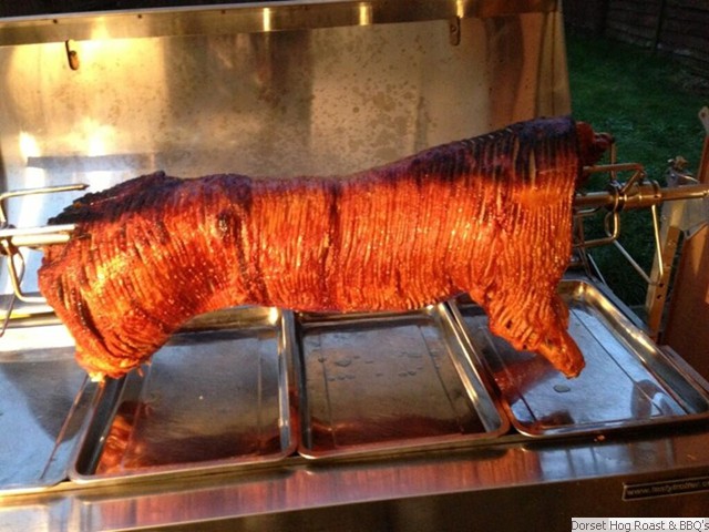 hog_is_rasied_up_prior_to_carving_so_people_to_have_a_look